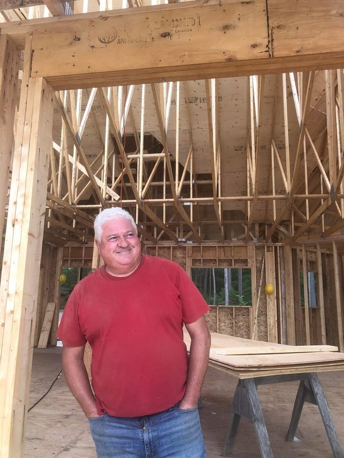 Ron standing inside the framed great room