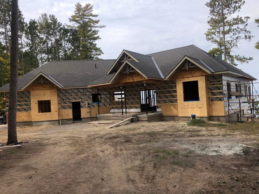 The house with its roof on, seen from the driveway