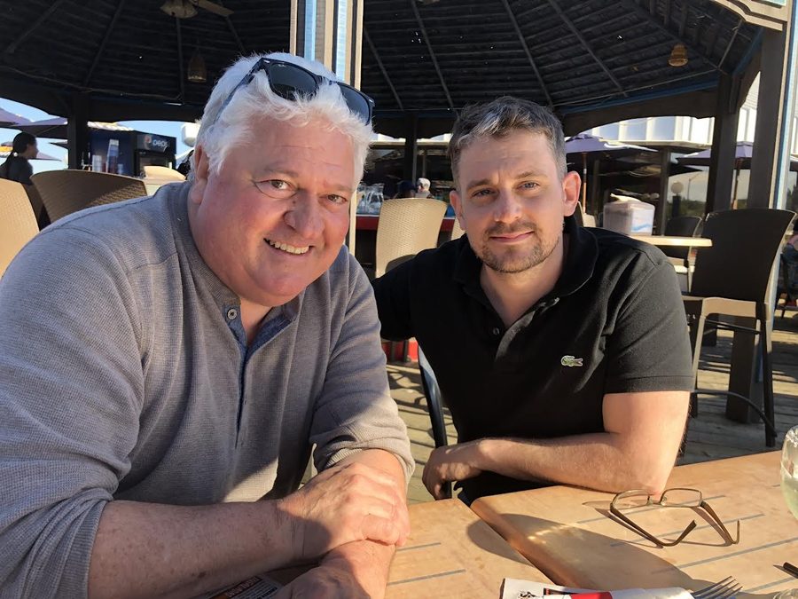 Ron with a son at a waterside restaurant